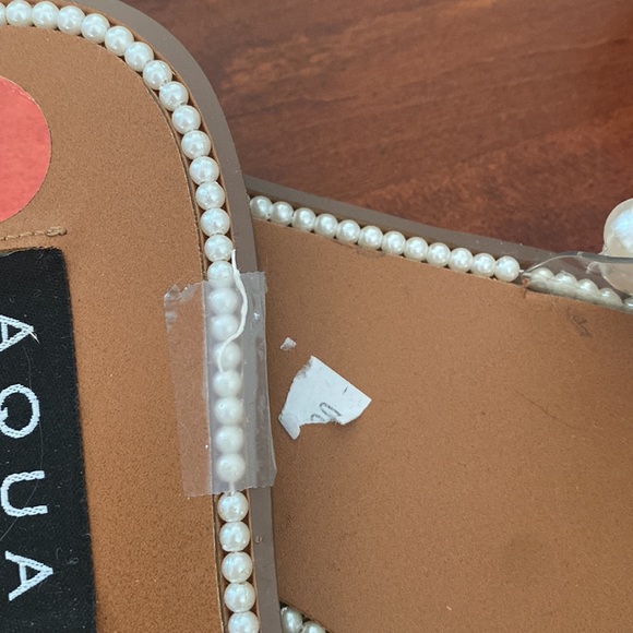 Flat slide sandals with faux pearl embellishment
Slip-on style
.75 inch heel - Picture 2 of 2